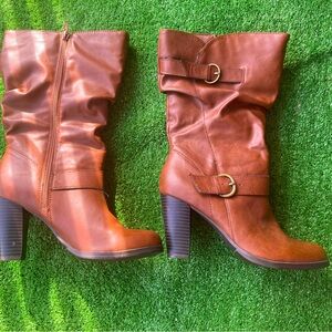 Mid-calf brown heeled boots which are lightly worn